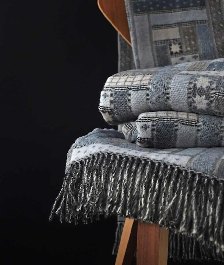 log cabin patchwork blue sofa throw woven from soft merino wool