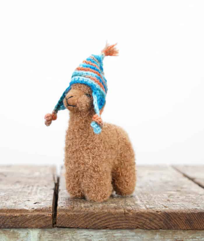 handmade baby alpaca soft toy with a hat