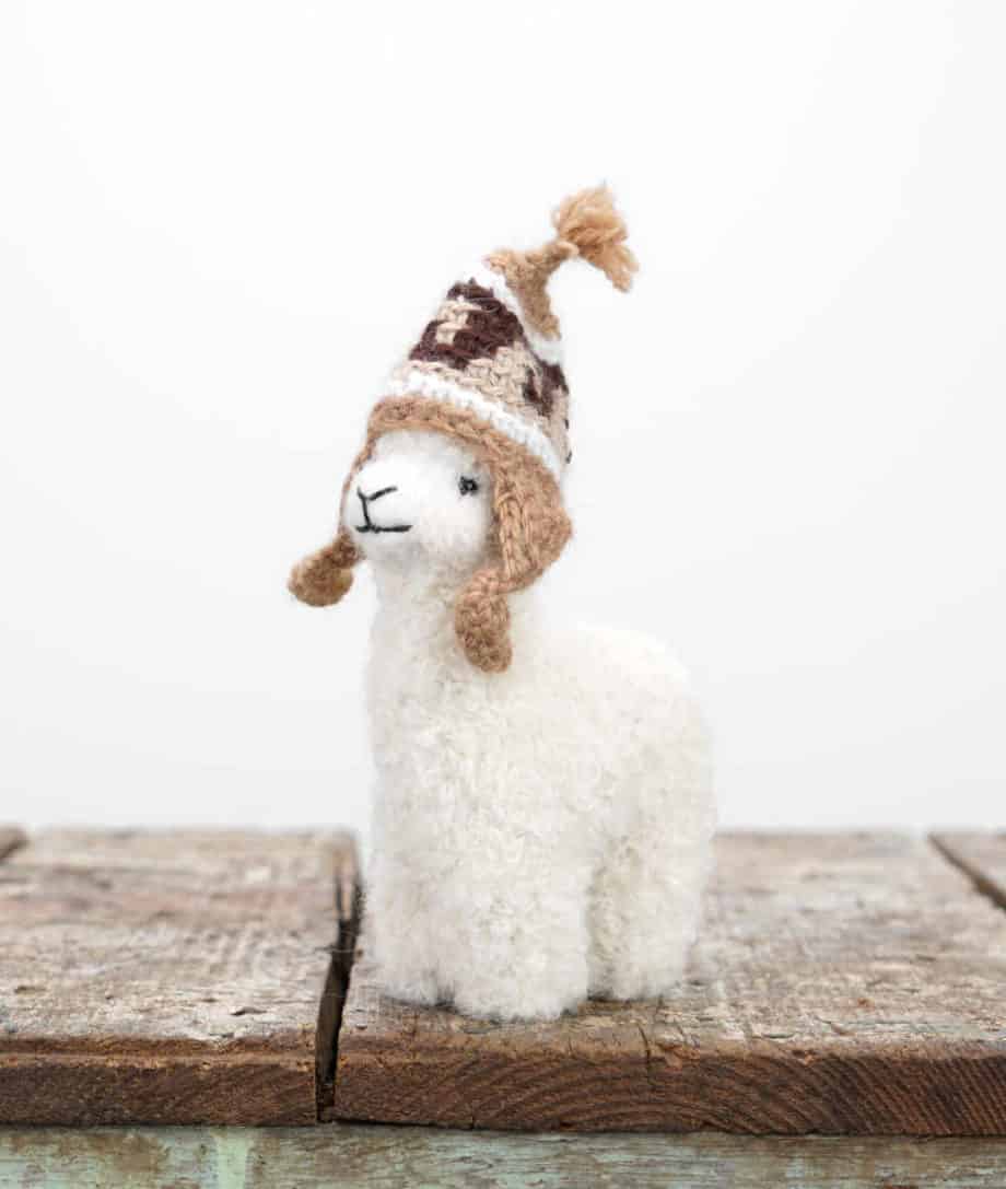 super cute hand felted white baby alpaca soft toy with a brown hat