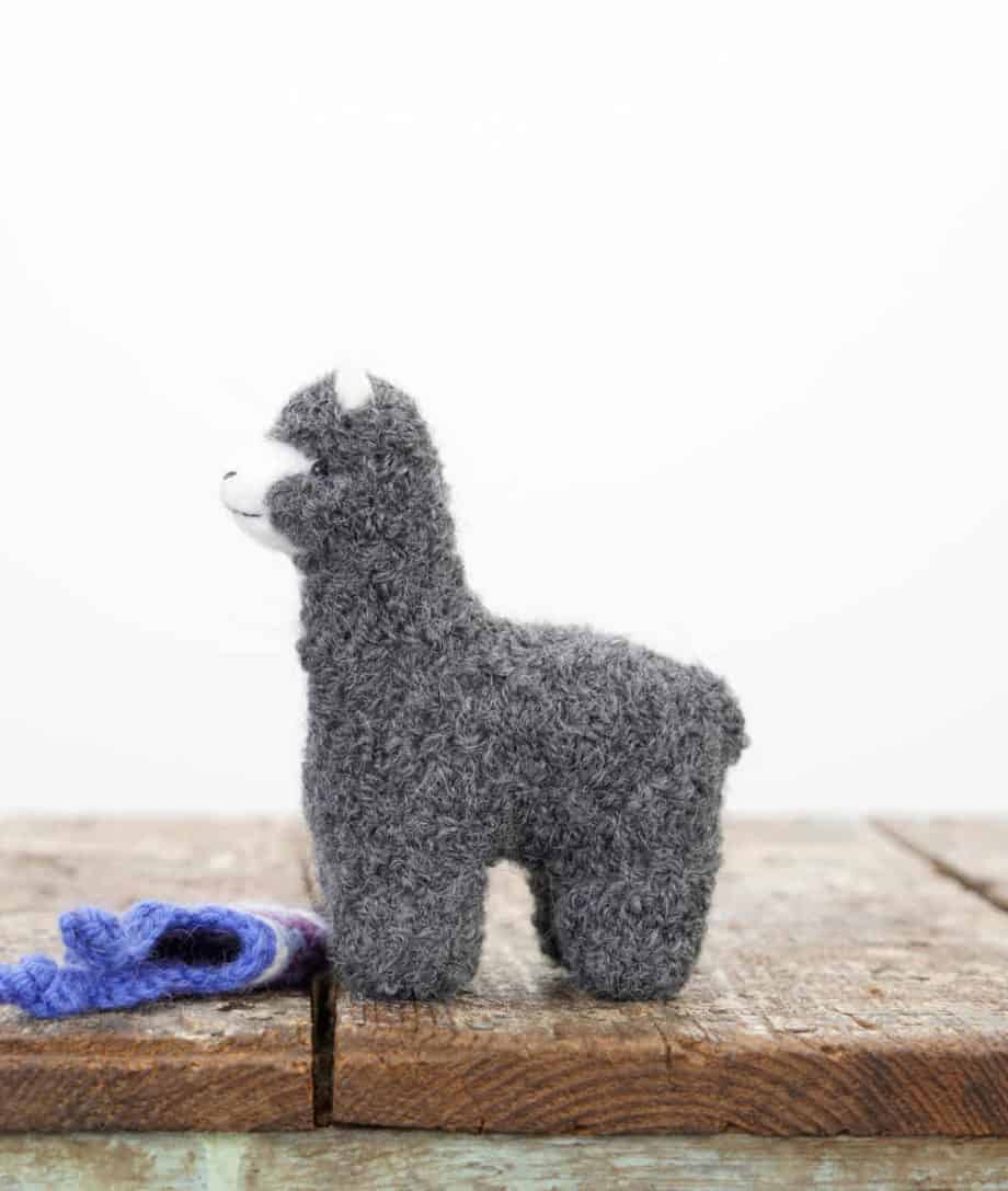 grey alpaca soft toy with blue hat