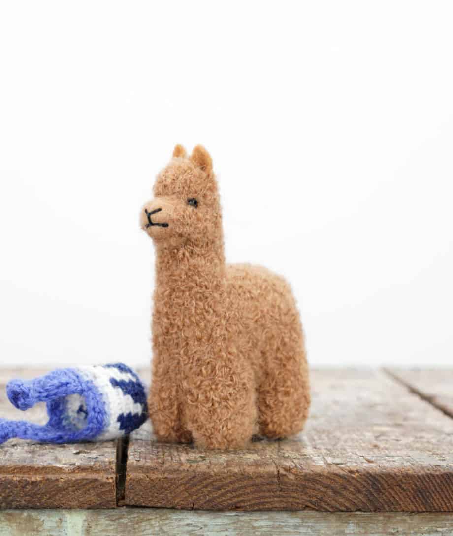 hand felted baby alpaca soft toy with a blue hat