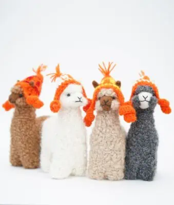 cute handmade baby alpacas with orange hats