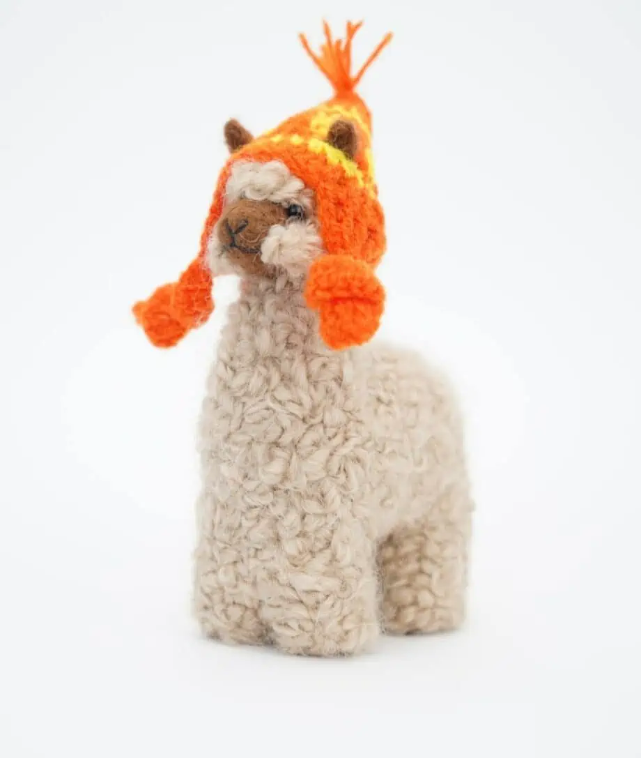 Beige cosy baby alpaca soft toy with hand crochet orange hat