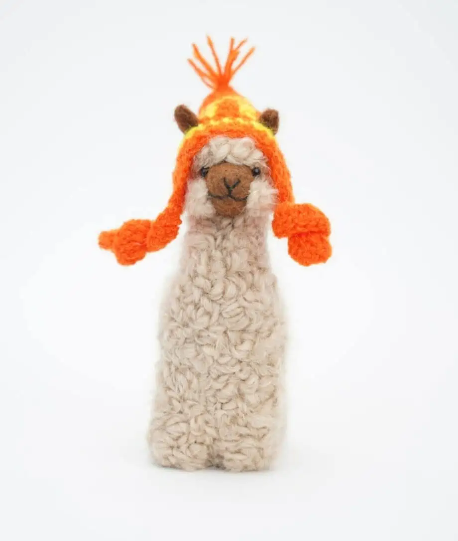 Beige baby alpaca soft toy with an orange hand crochet hat