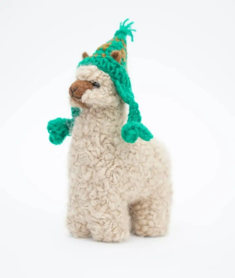 cosy baby alpaca soft toy with hand crochet green hat