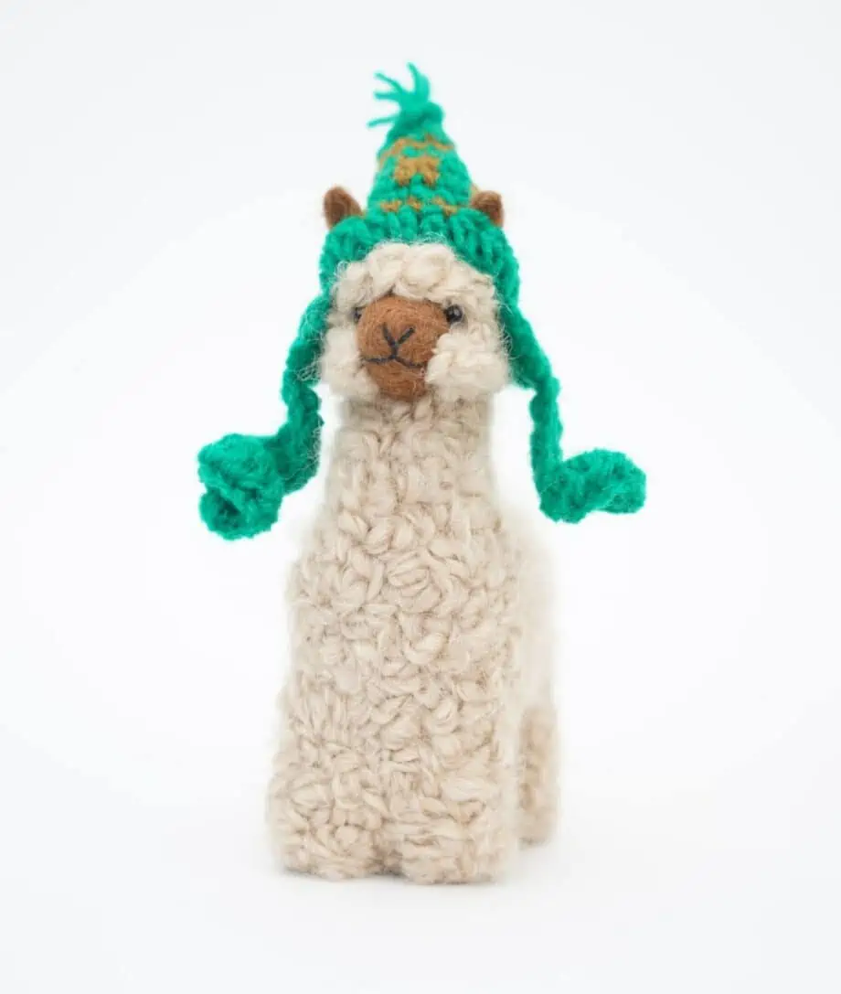 adorable baby alpaca soft toy with a green hat