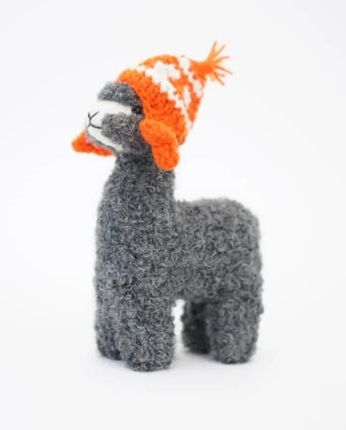 cute grey baby alpaca wool soft toy with an orange hat