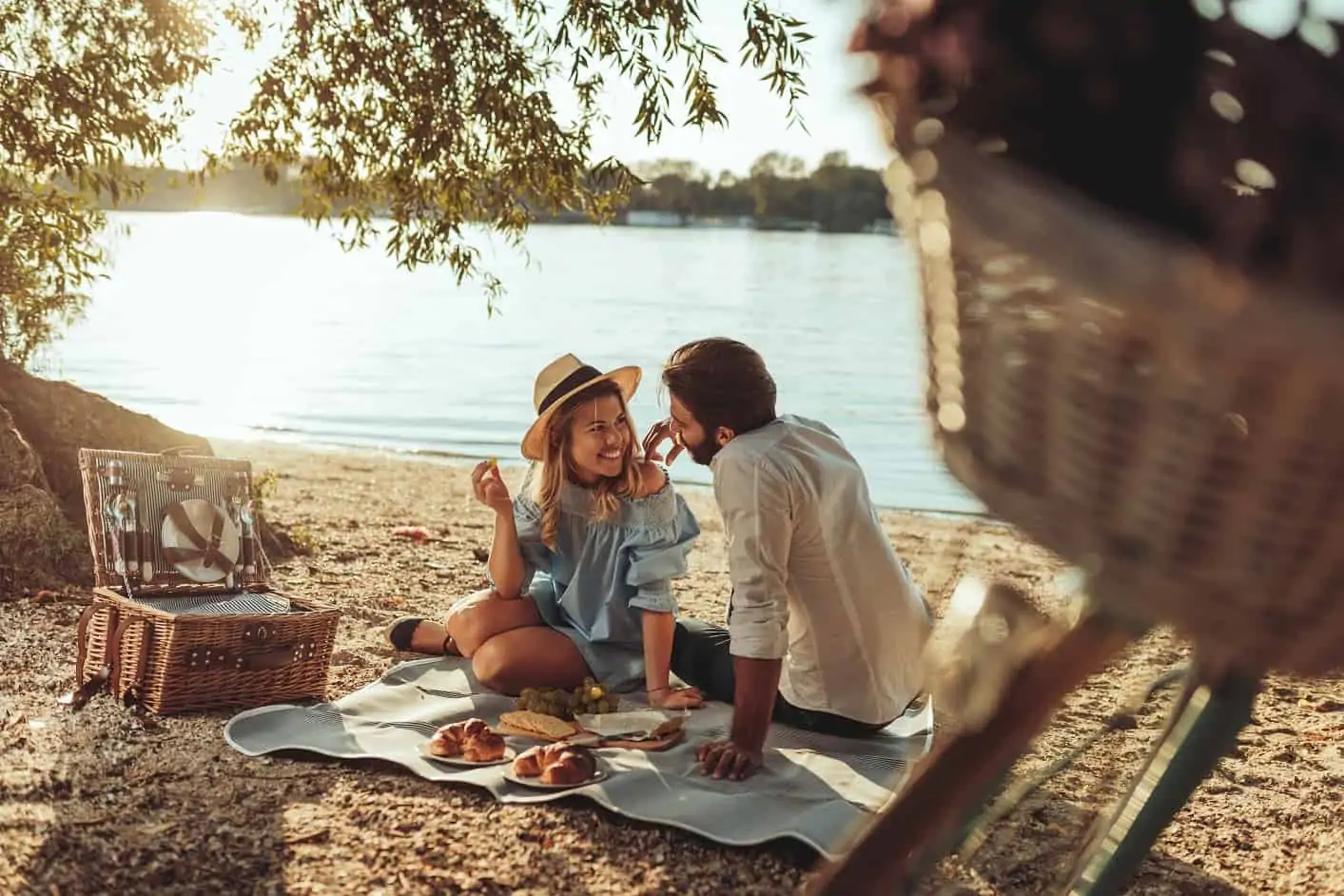 Romantic beach picnic with a luxury picnic basket