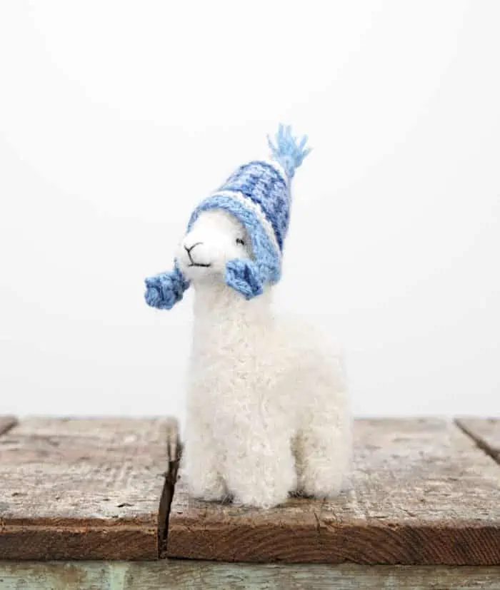 super cute hand felted peruvian baby alpaca soft toy with a blue hat