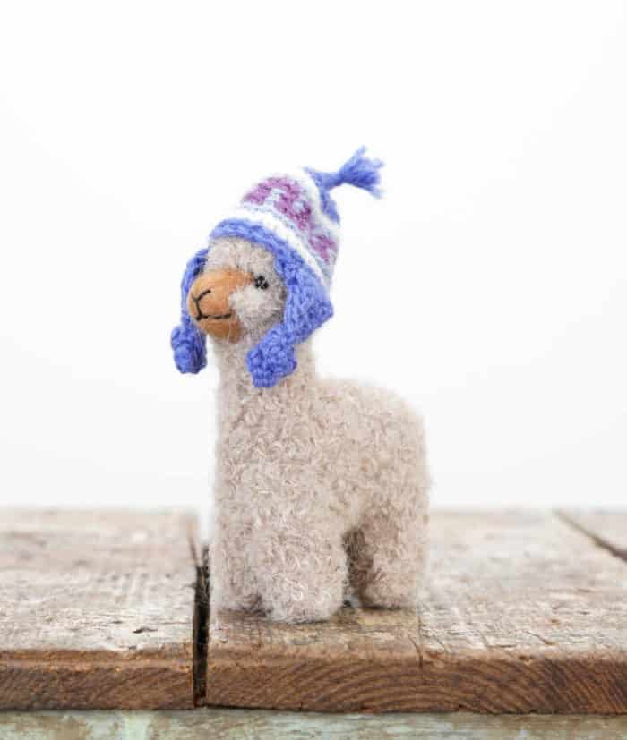 soft hand felted baby alpaca toy with blue hat