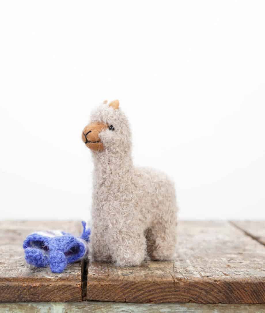 soft baby alpaca toy with blue hat