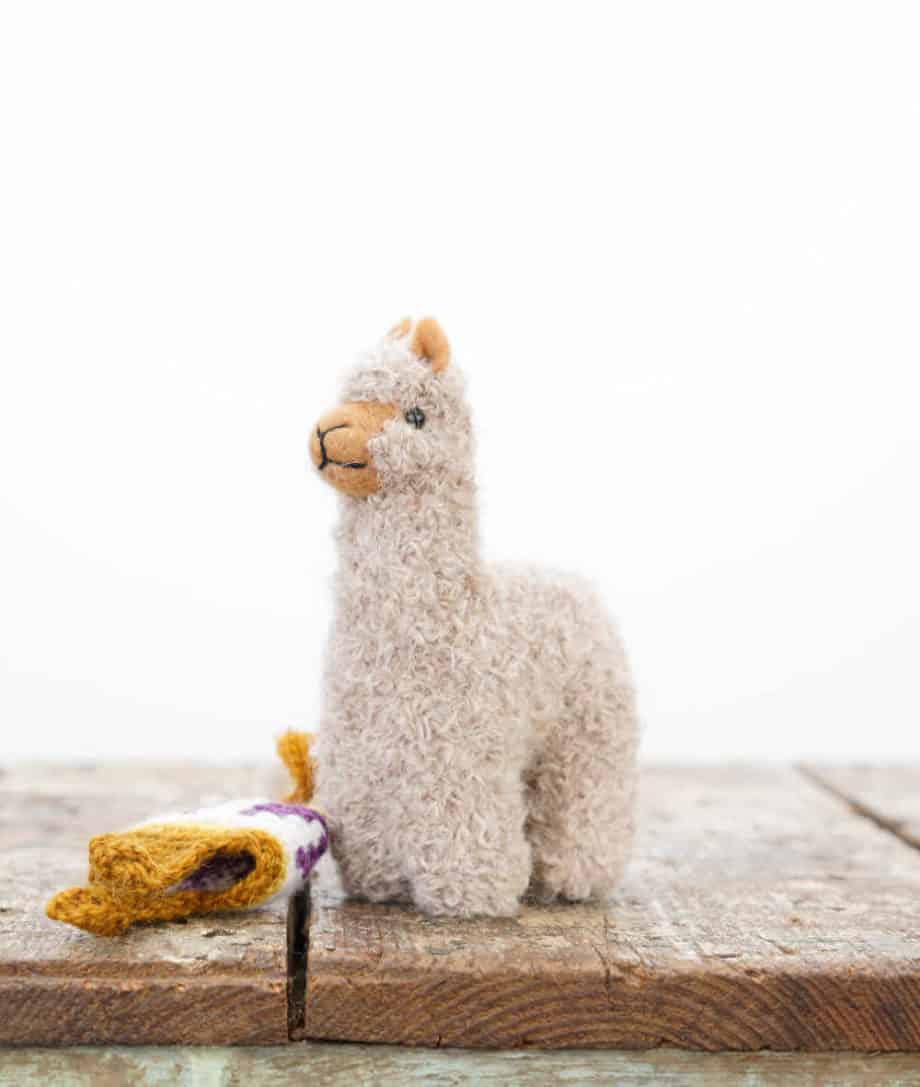 handmade alpaca toy with a sandy taupe hat