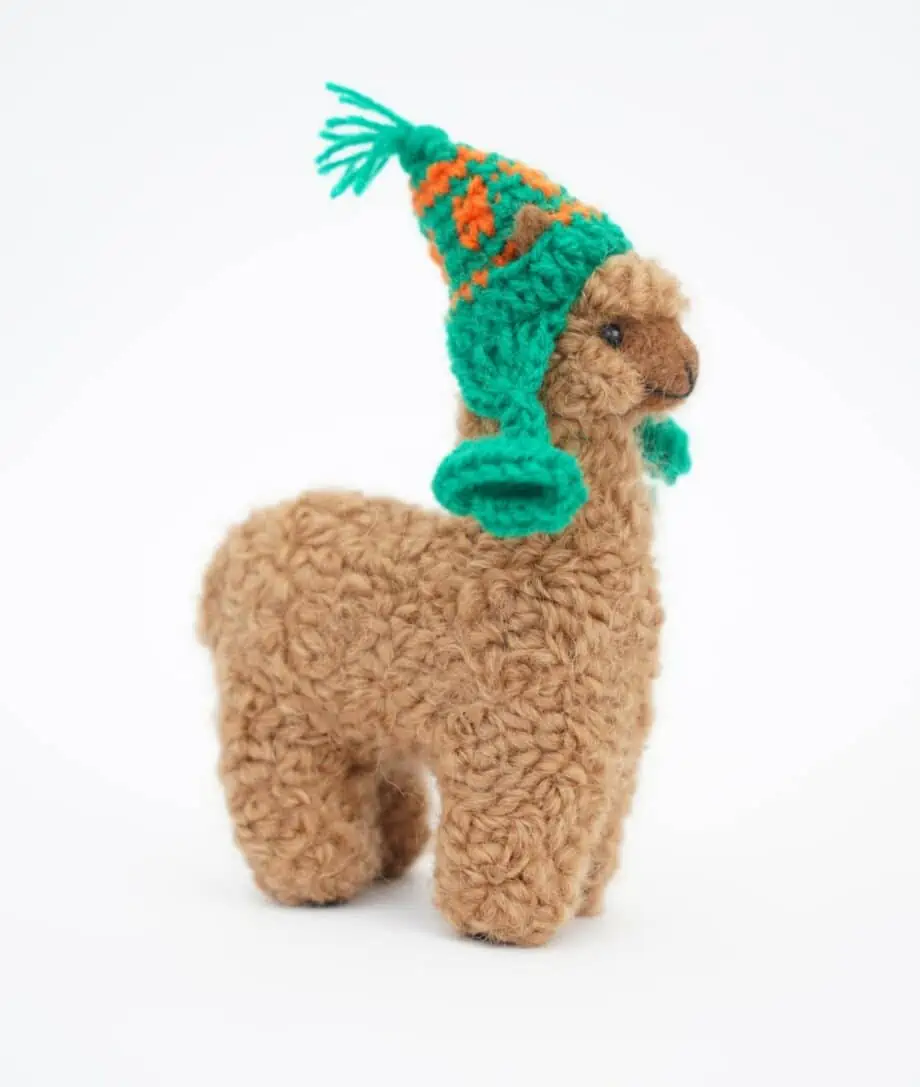 handmade cute baby alpaca soft toy with had-crochet green hat