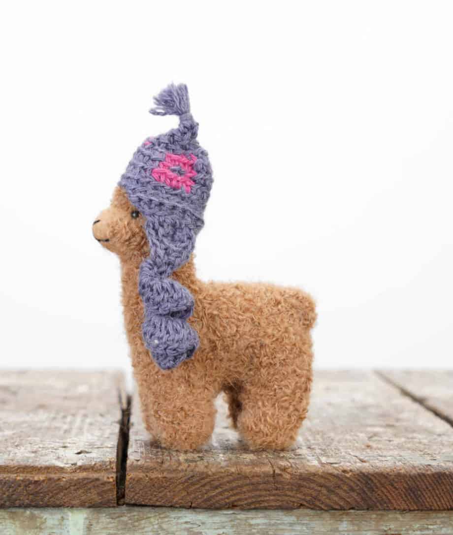 brown baby alpaca soft toy with a hat