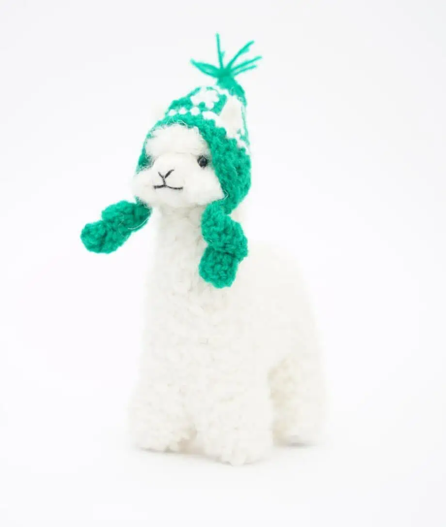 cute hand made white baby alpaca soft toy with a green hat