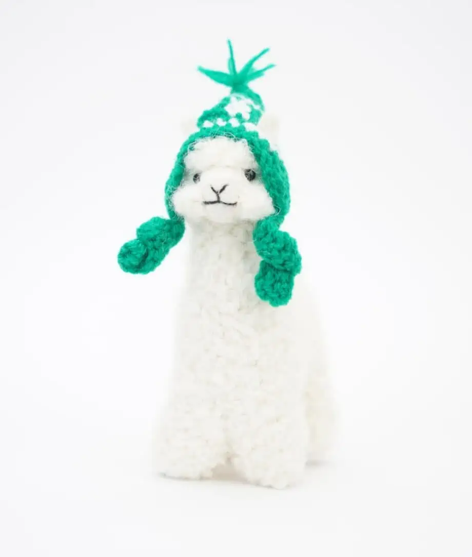hand made white baby alpaca soft toy with green hand crochet hat