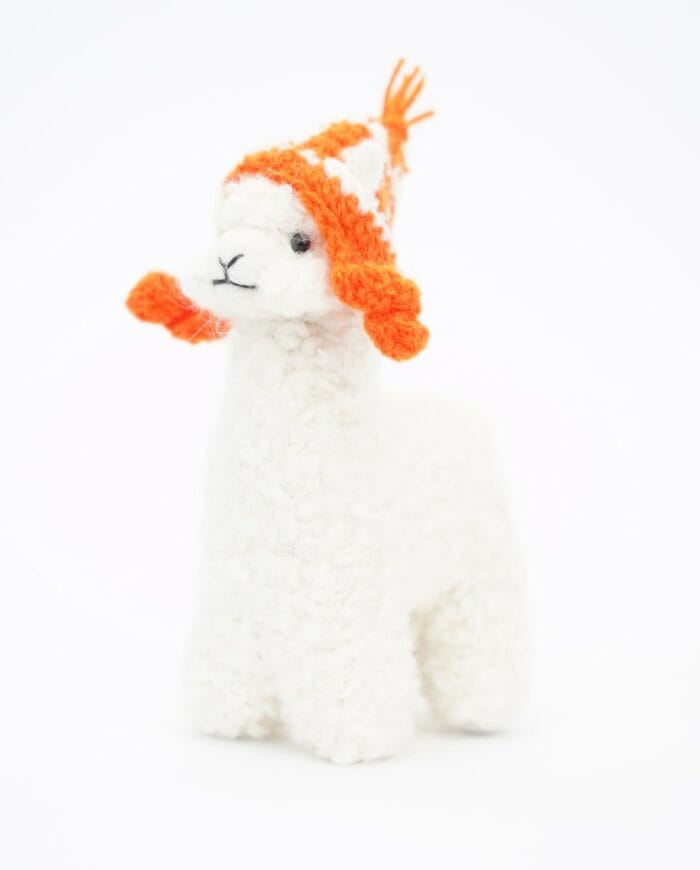 white baby alpaca soft toy with an orange hat