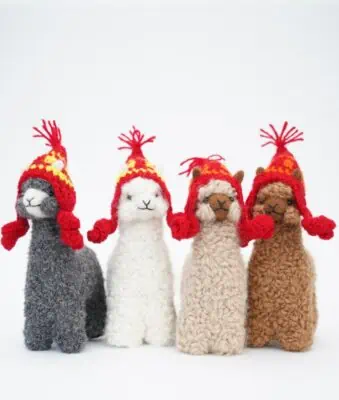 cosy baby alpacas with red hats