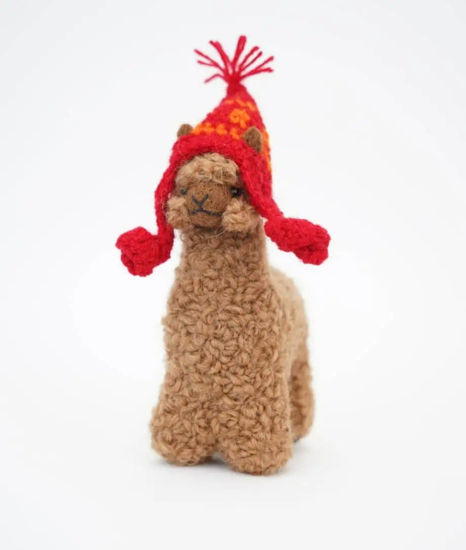 cute brown baby alpaca with a red hat