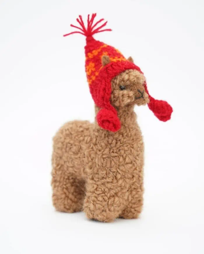 Brown baby alpaca wool with a red hat