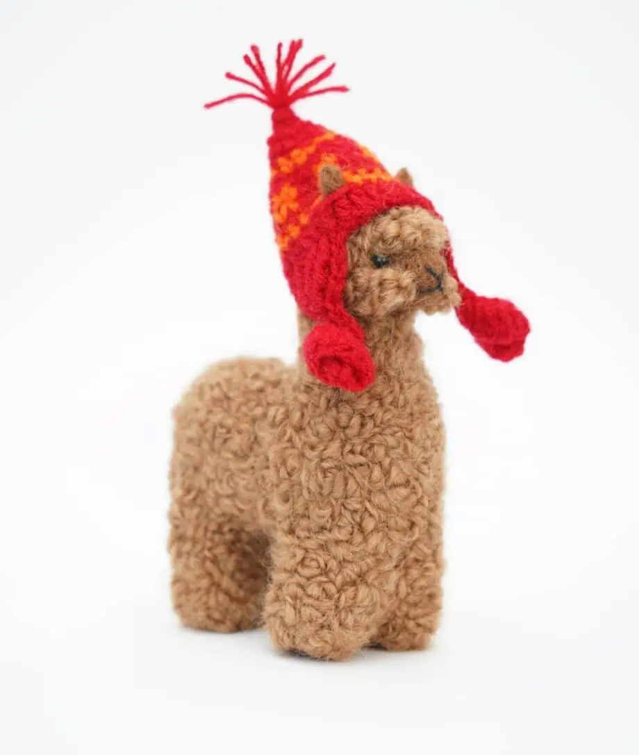 Brown baby alpaca wool with a red hat