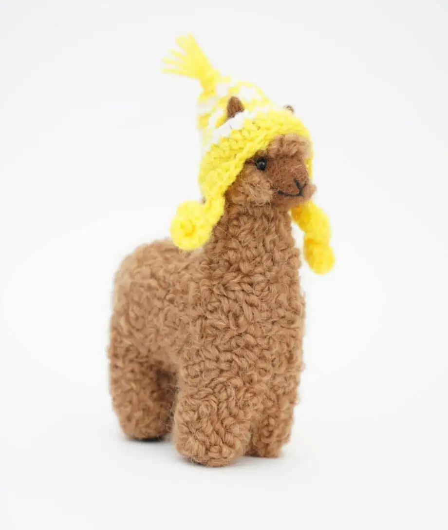 adorable brown baby alpaca soft toy with a yellow hat