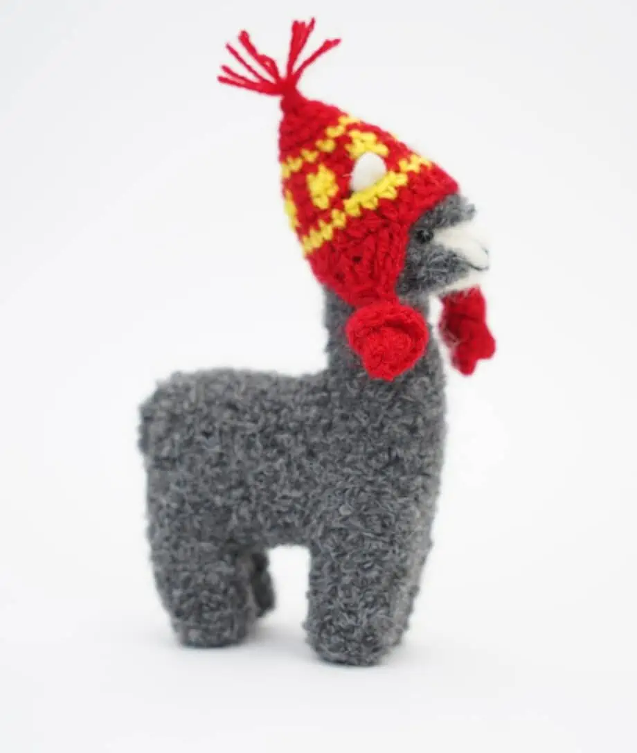 cuddly grey baby alpaca soft toy with a red hat