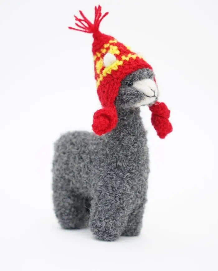 cure grey baby alpaca with a red hat