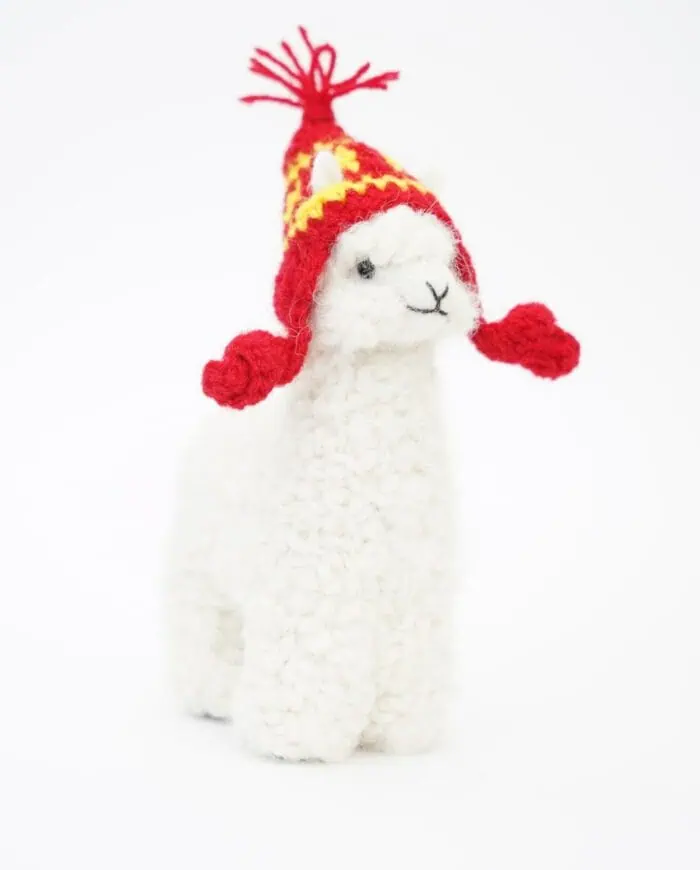 adorable baby alpaca soft toy with a red hat