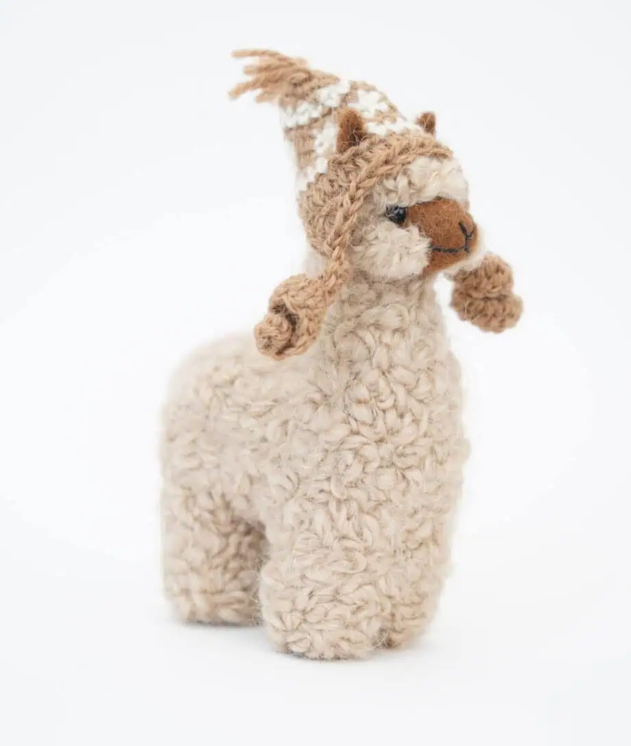 beige alpaca soft toy with a hat