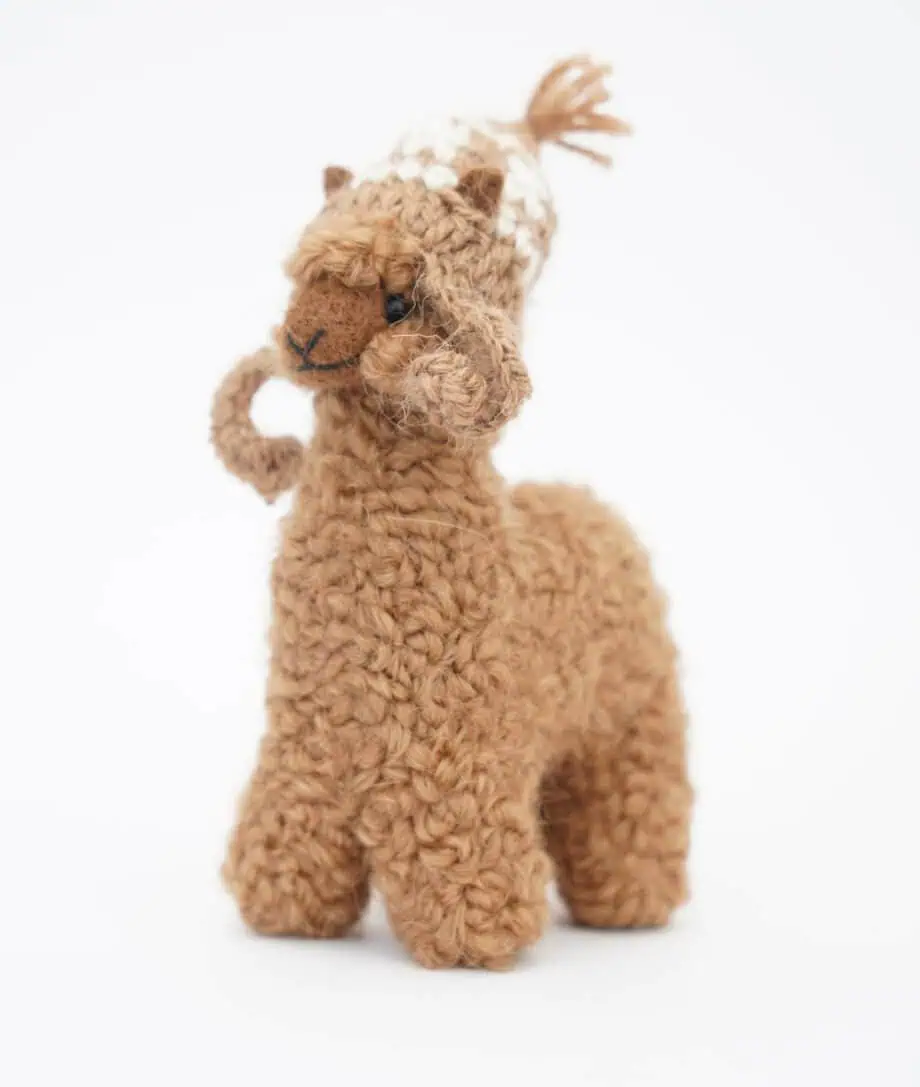 cuddly baby alpaca soft toy with a brown hat
