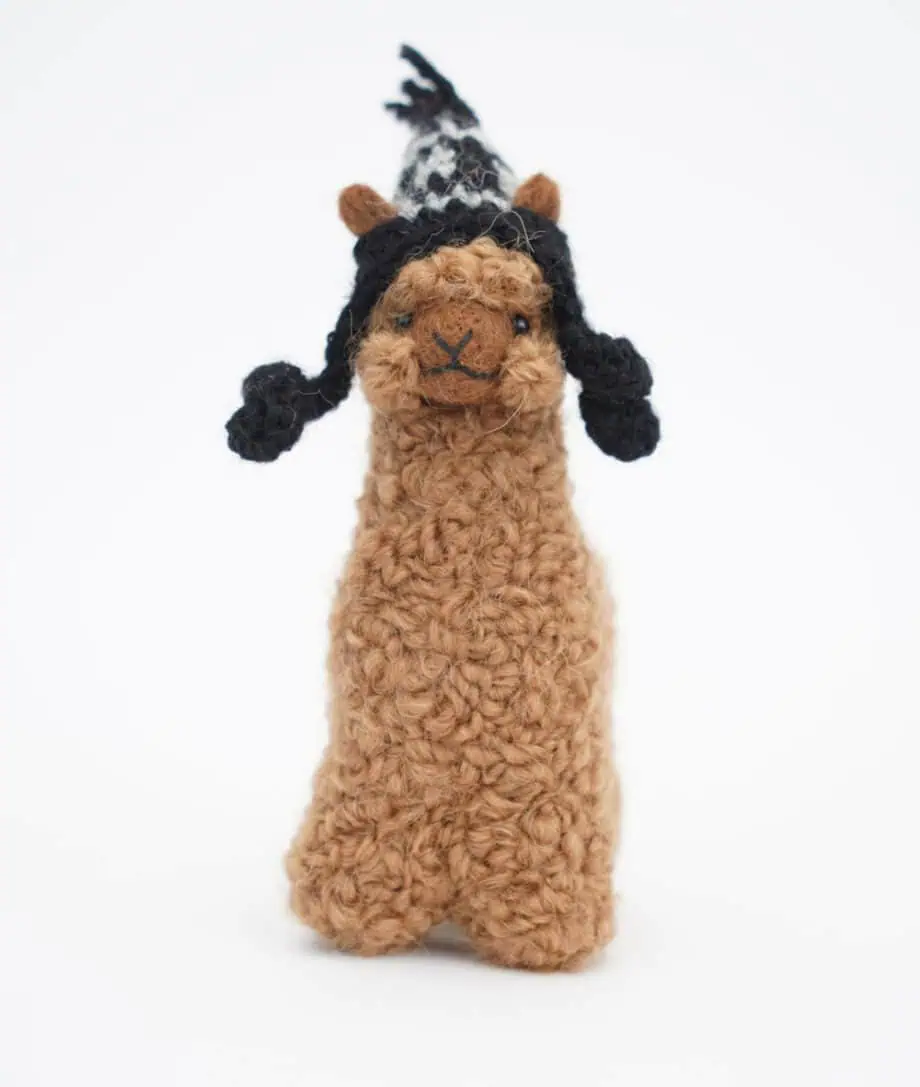 brown alpaca with a black hat