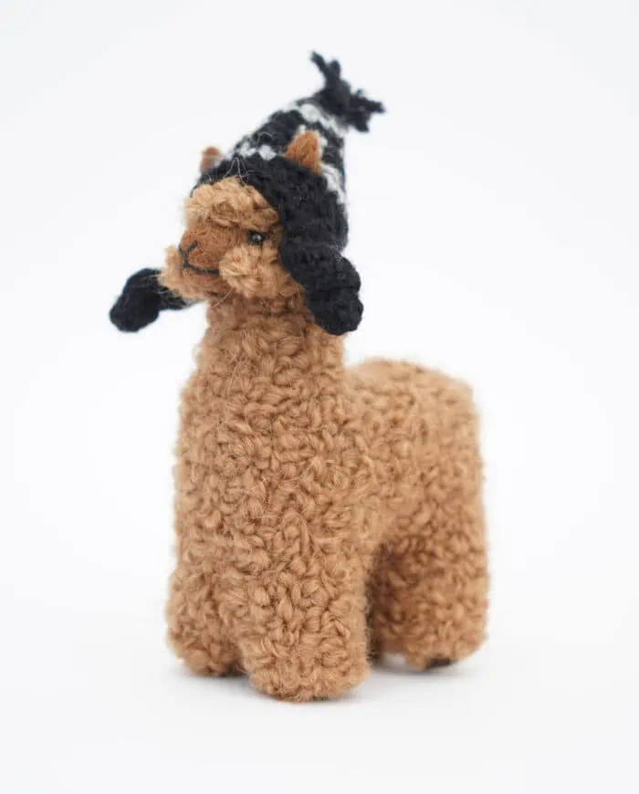 cute brown baby alpaca soft toy with a black hat