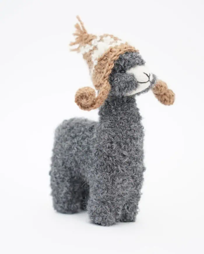 cosy grey baby alpaca soft toy with a brown hat