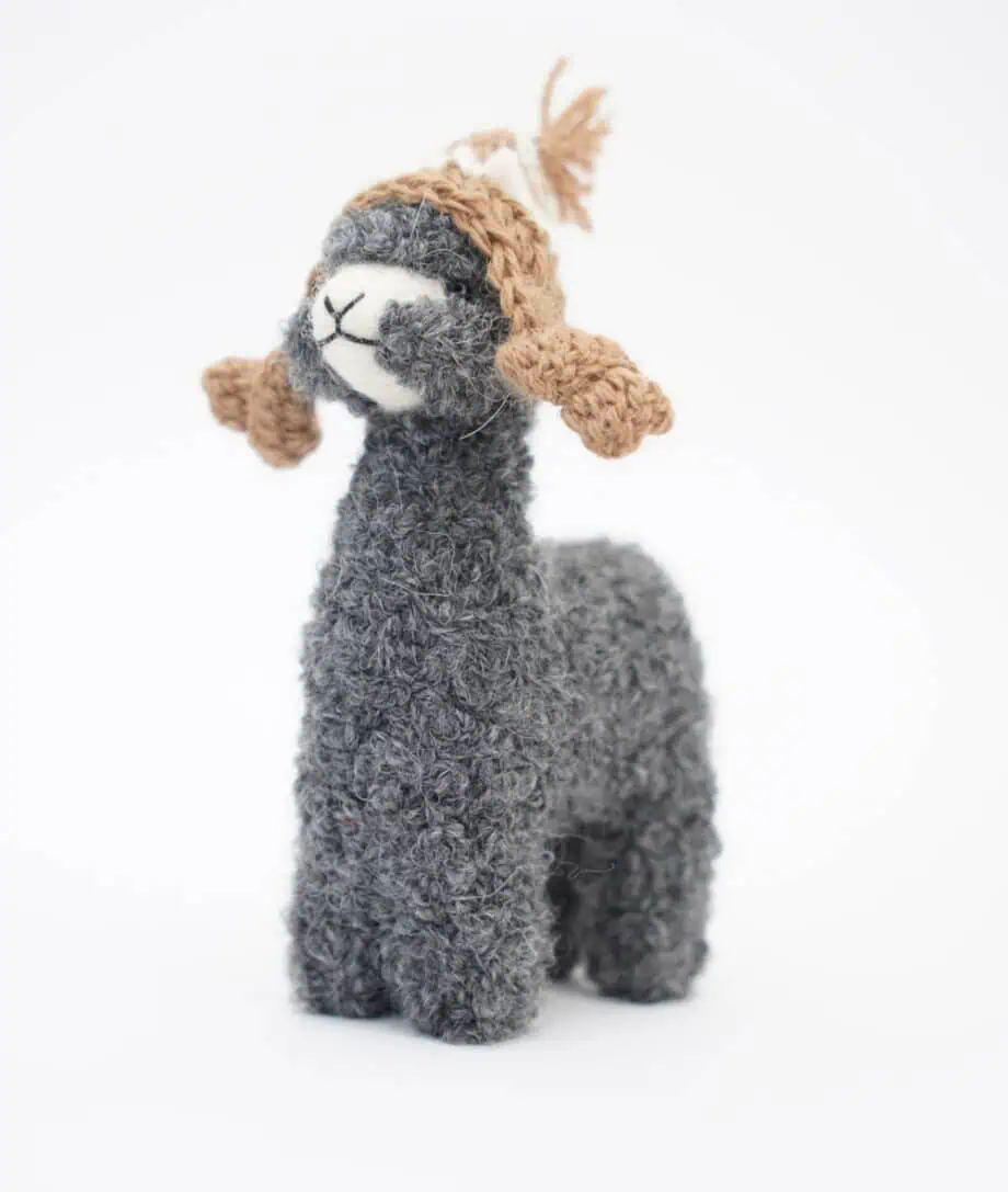 grey baby alpaca soft toy with a brown hat
