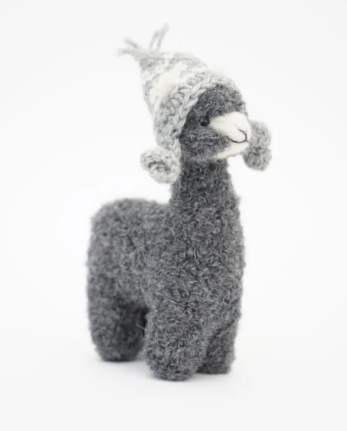 cute grey alpaca with a grey hat