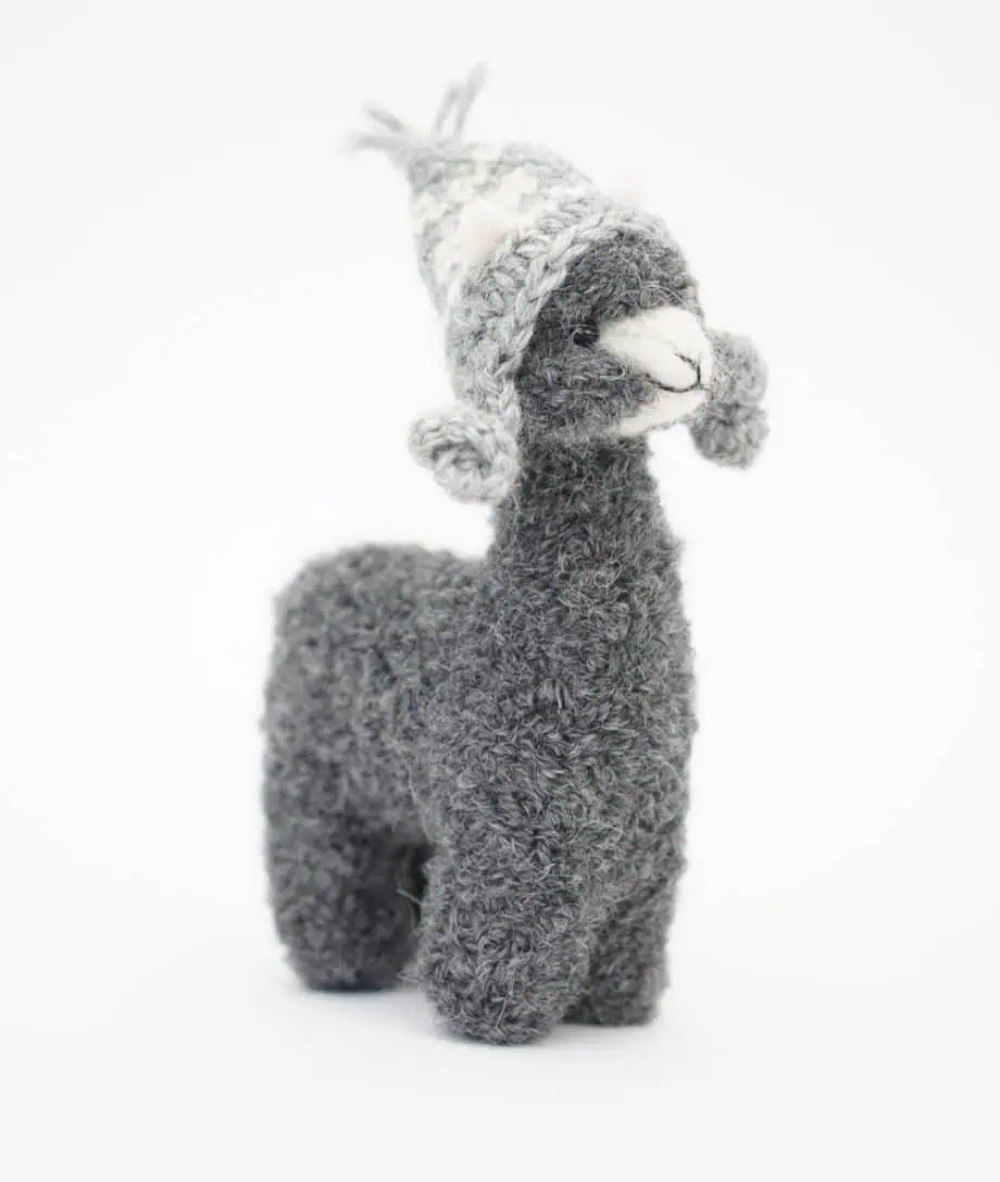 cute grey alpaca with a grey hat