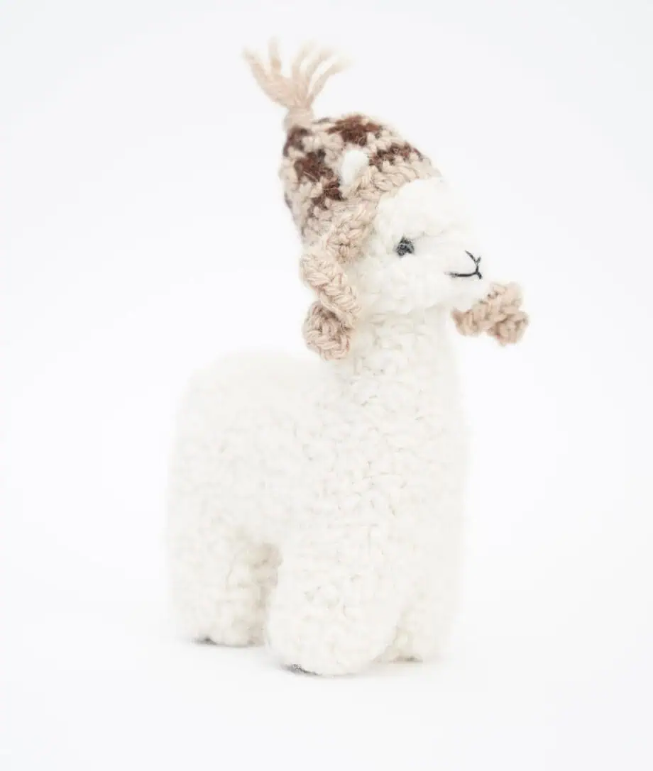 white baby alpaca soft toy with a handcrocher hat